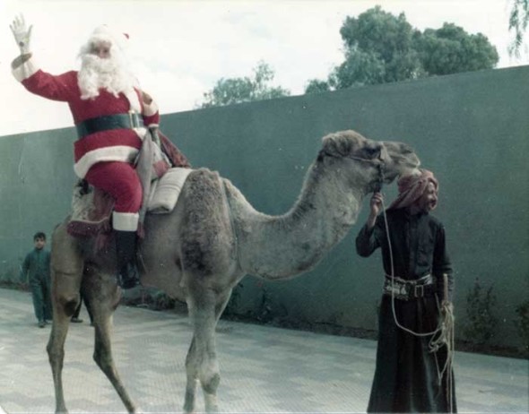 Santa Claus parading around on a camel somewhere on the Arabian peninsula. Circa 1970s. Norbert Schiller Collection