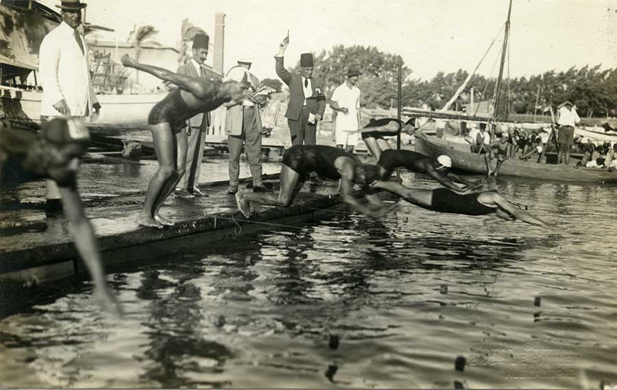 Male swimmers dive into the water at the start of their race. Norbert Schiller Collection Phot. Sellian